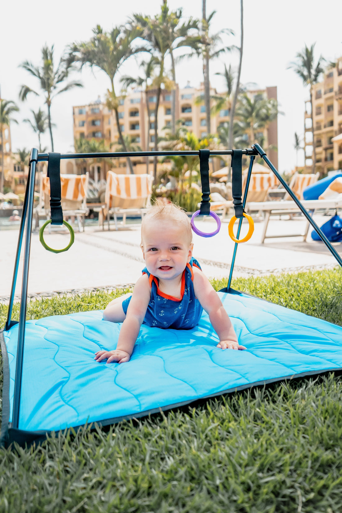 Baby playing on a portable travel baby play mat while traveling