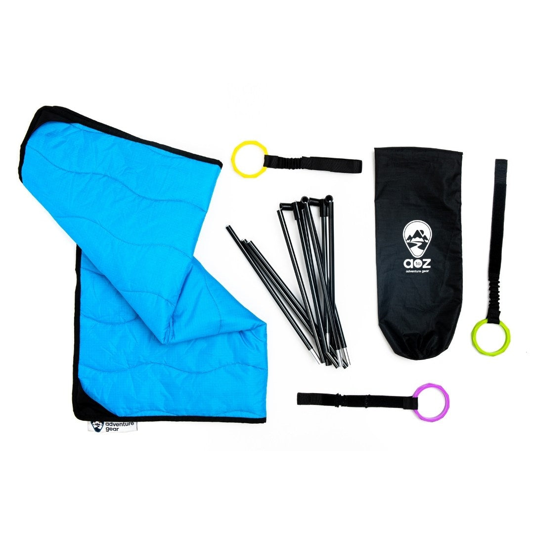 Flatlay photo of Lay and Play Adventure Mat activity gym, includes blue padded mat, poles, three rings and stuff sack. 
