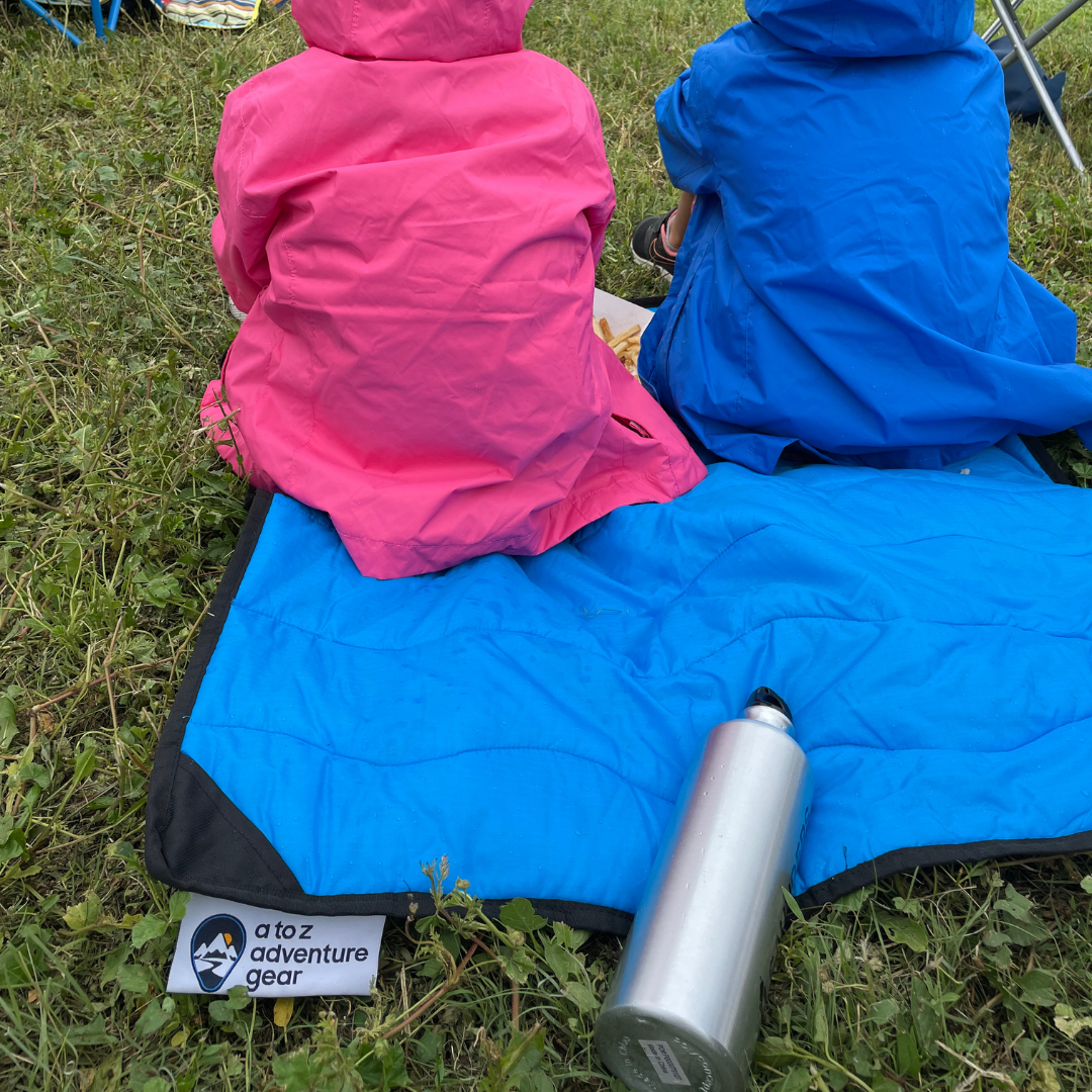 Close-up of the Adventure Mini Mat’s textured, waterproof surface with vibrant teal and navy color accents and stitched